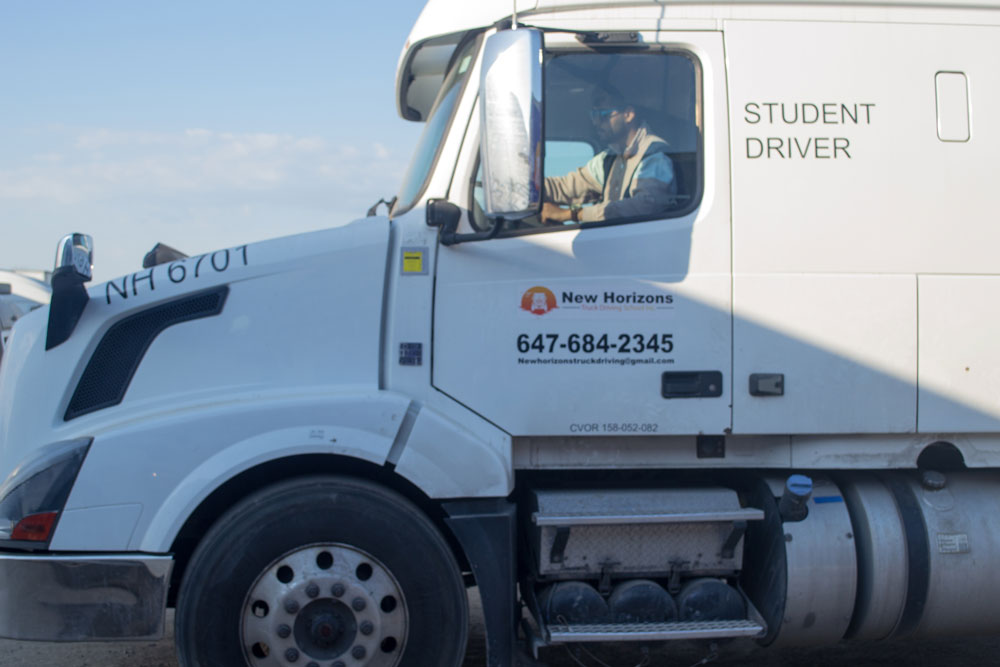 Close-up of NH 6701 cab with Student Driver lettering and instructor inside