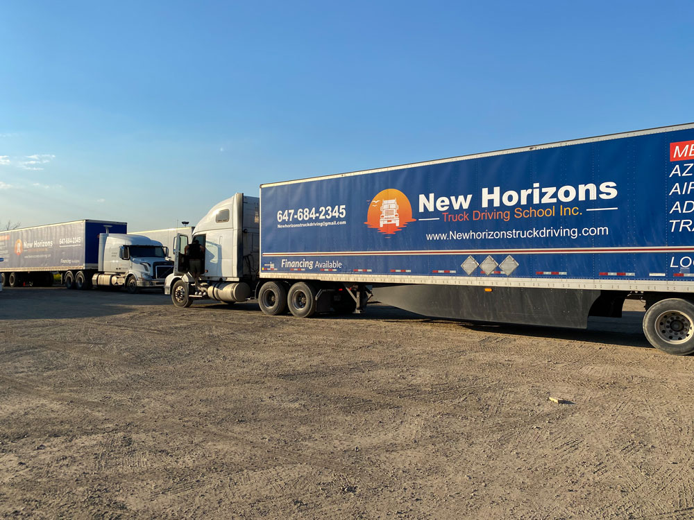 Long combination of Volvo tractor and branded trailers parked at yard