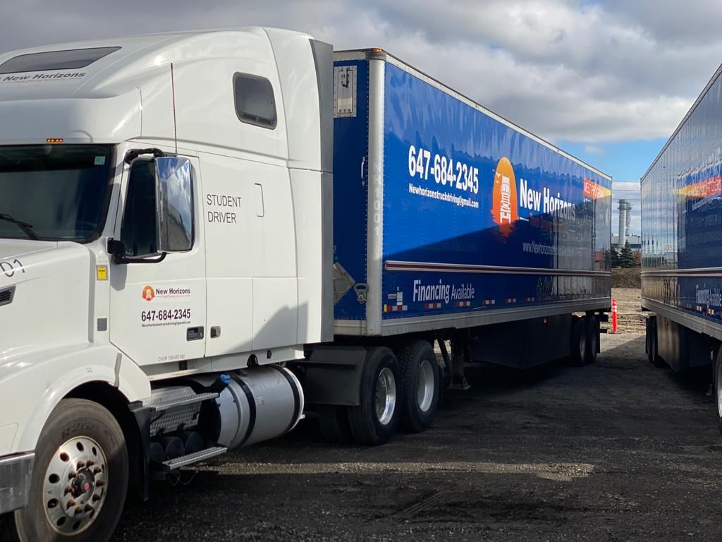 Volvo sleeper cab with Student Driver door lettering and branded trailer